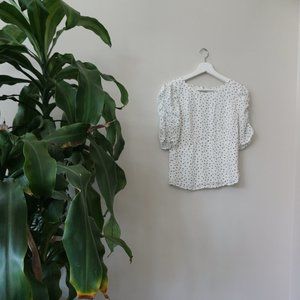 Polka dot shirt with partial open back and ruffled sleeves